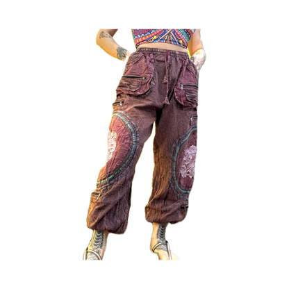 Front view of handmade burgundy Chris Dyer Dyer-Jawnz parachute pants featuring multiple cargo pockets, patchwork details, and a relaxed fit.