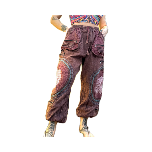 Front view of handmade burgundy Chris Dyer Dyer-Jawnz parachute pants featuring multiple cargo pockets, patchwork details, and a relaxed fit.