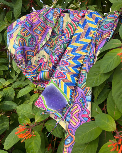    Detail of Chris Dyer Expanding Lightworker reversible pashmina with vibrant psychedelic artwork and tasseled edges