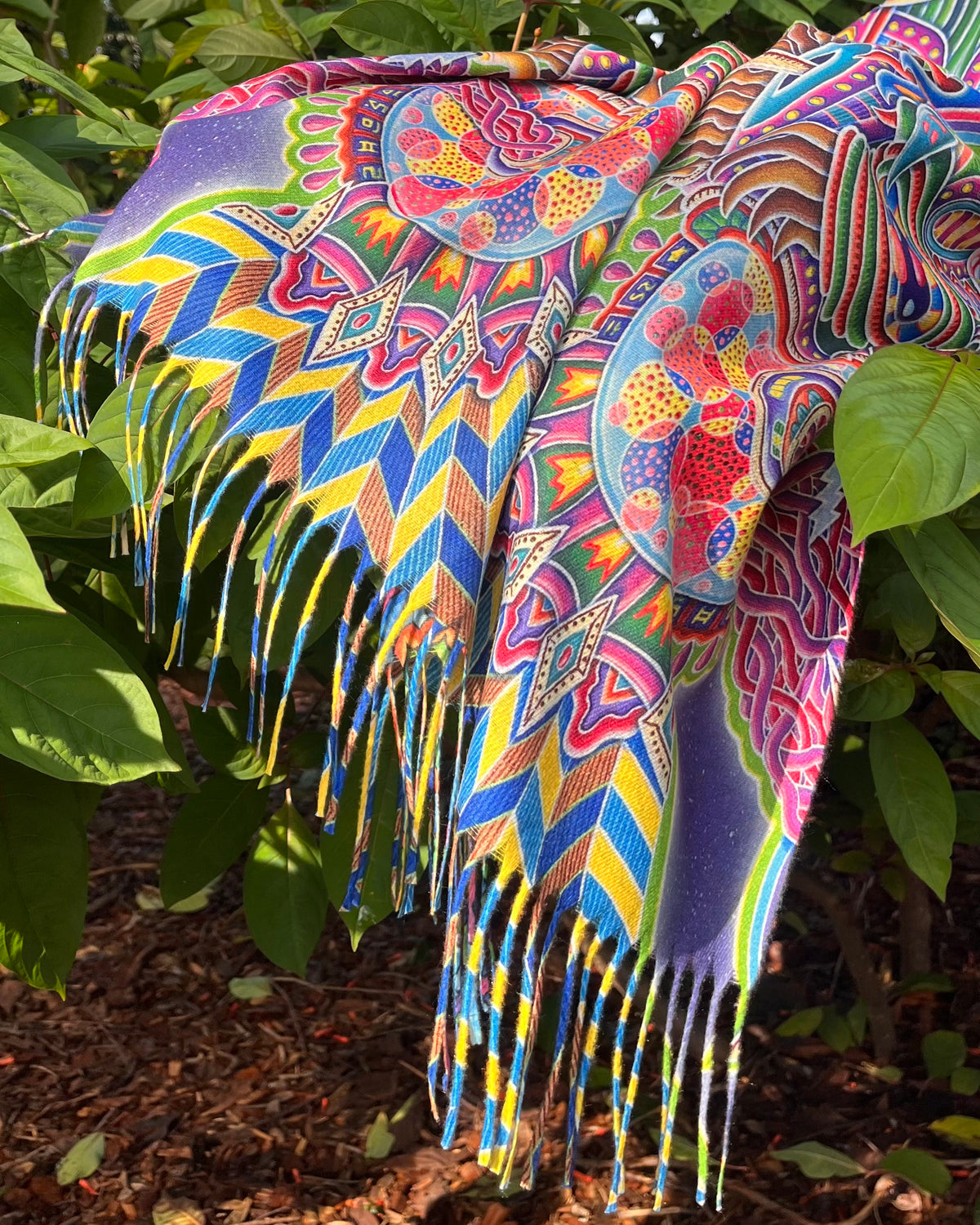     Detail of Chris Dyer Expanding Lightworker reversible pashmina with vibrant psychedelic artwork and tasseled edges