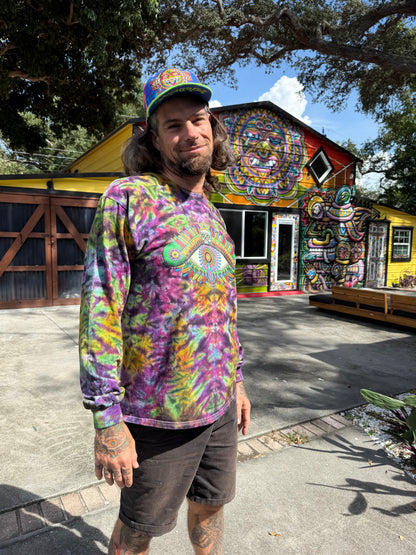 Chris Dyer wearing the Positive Eye Cosmic handmade tie-dye long-sleeve shirt in purple, blue and green