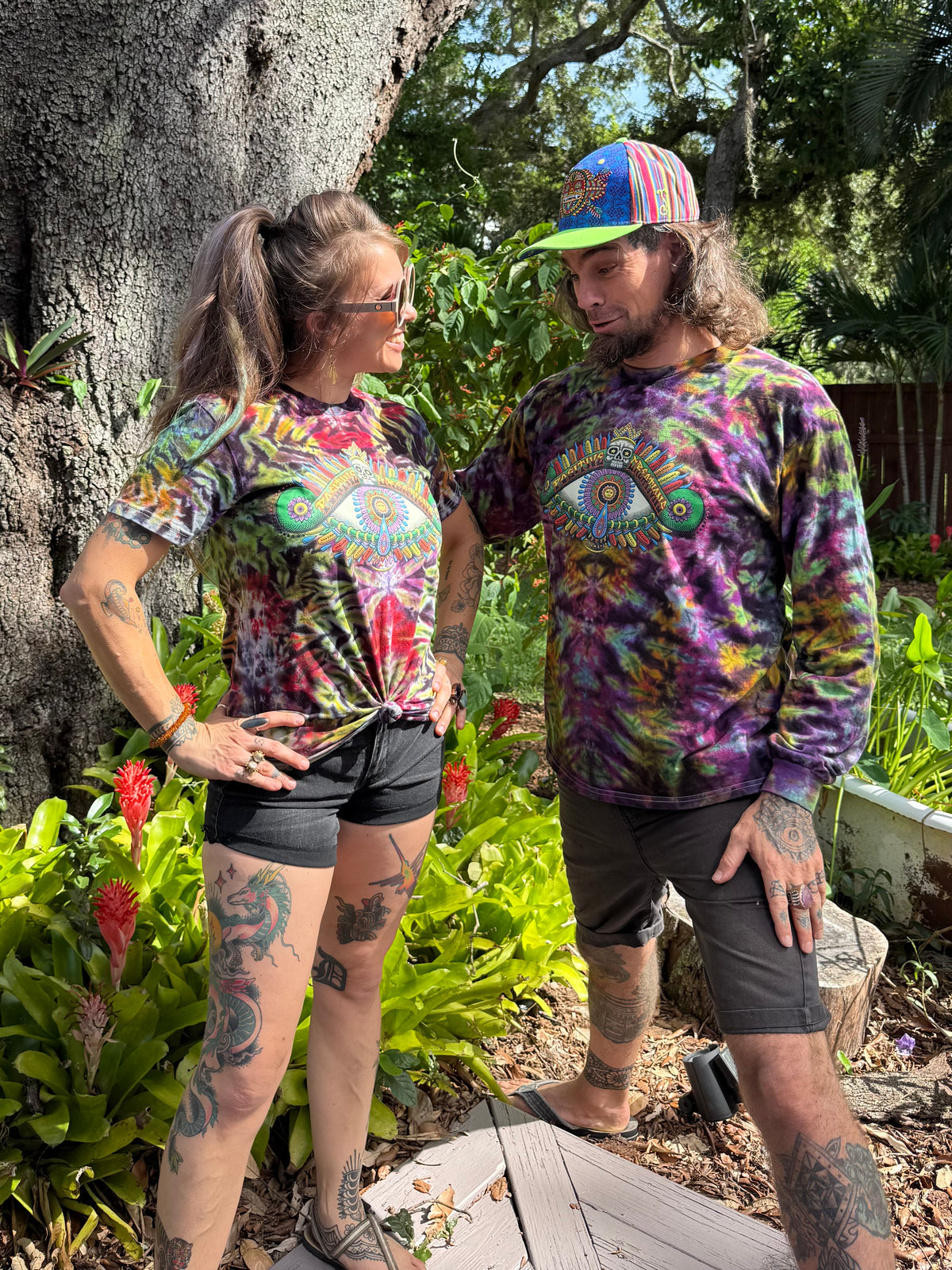 Positive Eye handmade tie-dye shirts by Chris Dyer modeled in the Earth and Cosmic 2026 colorways.
